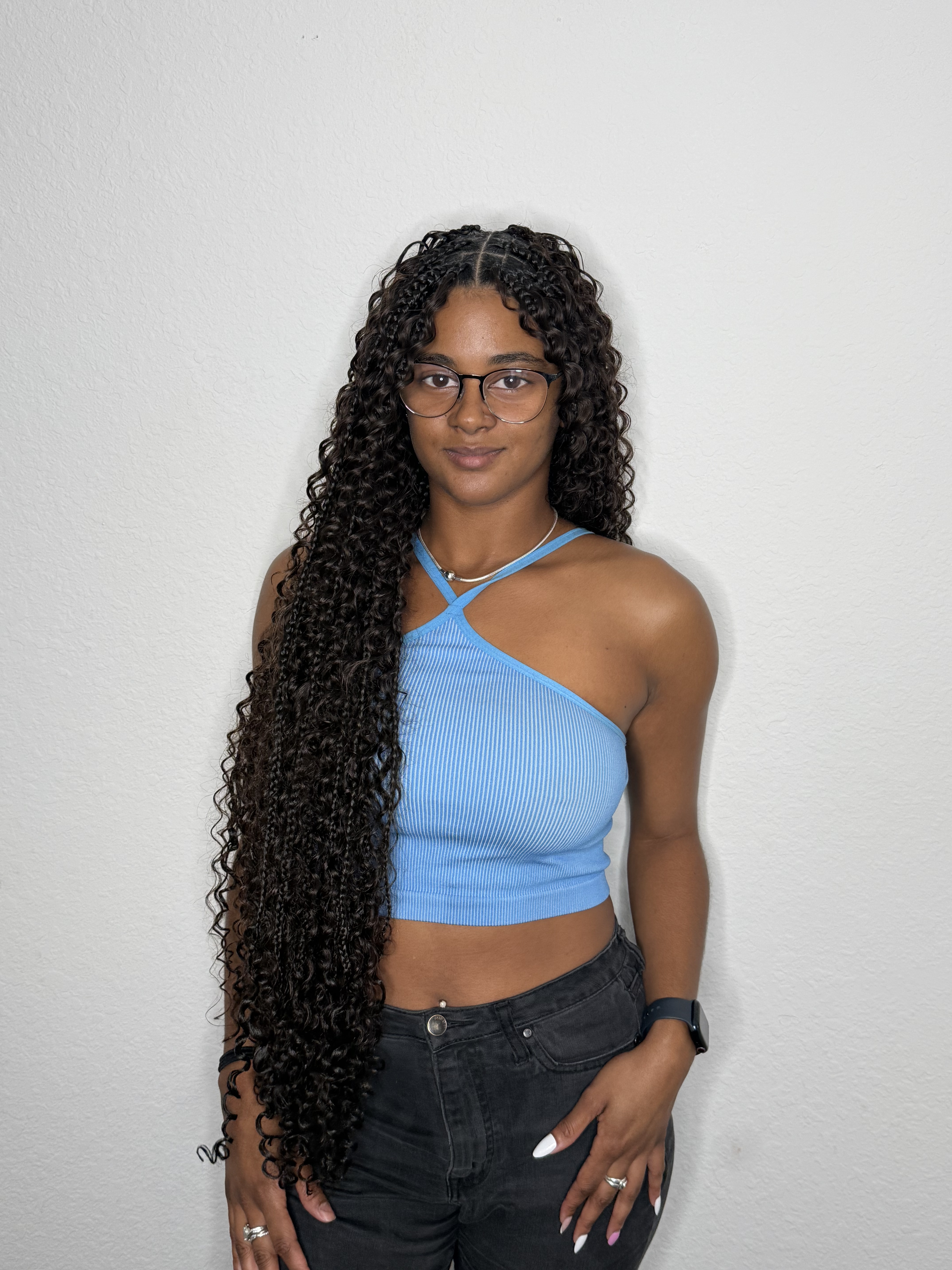 Young woman showing long protective braids by Yulis