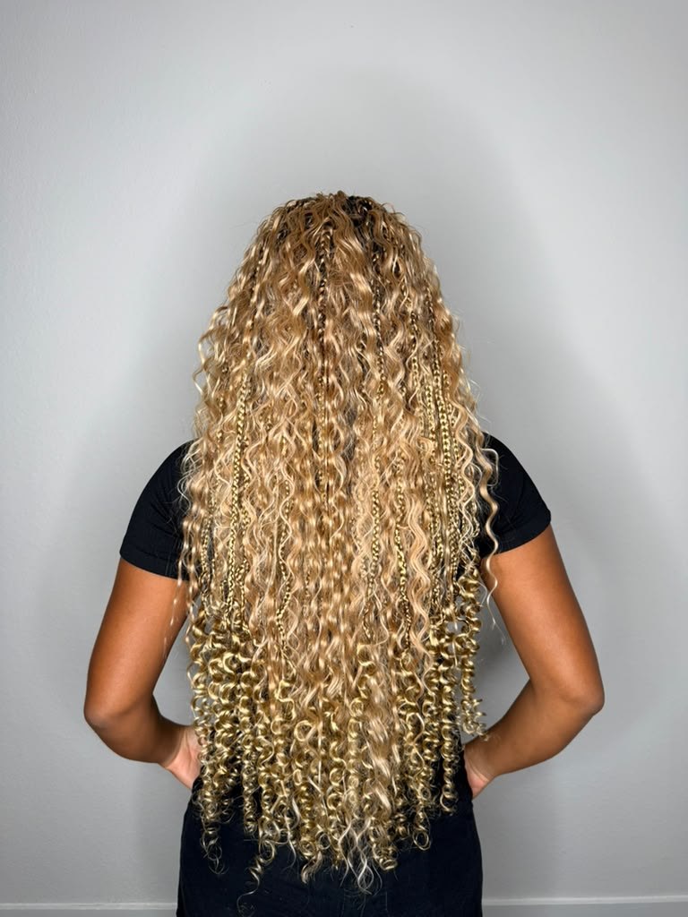 Long blonde curly braids and twists shown from the back